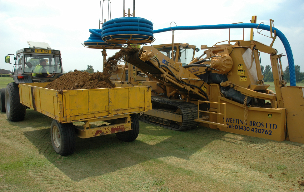 Carrier main installation on a football pitch