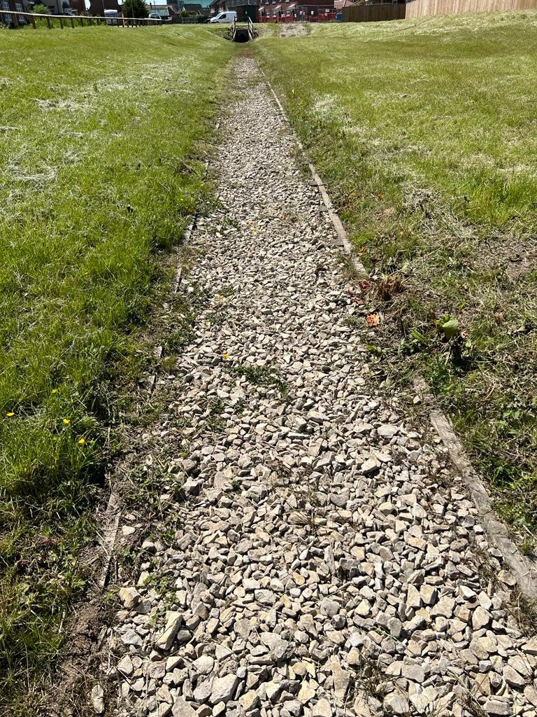 Completed maintenance track beside the attenuation basin