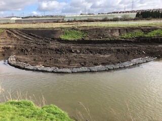 Completed rock berm beside the River Rother