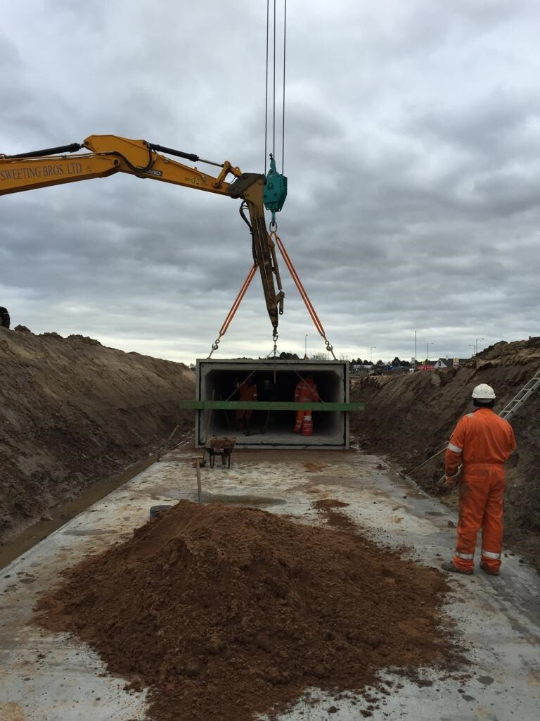 Concrete box culvert section being lifted into position
